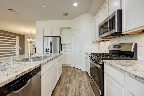 a view of a room with wooden floor and windows