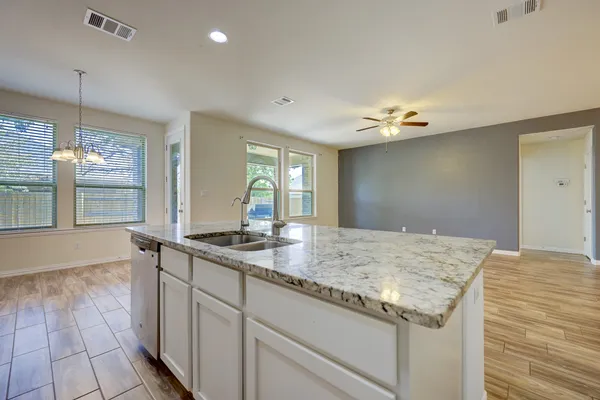 a view of kitchen with refrigerator microwave and stove
