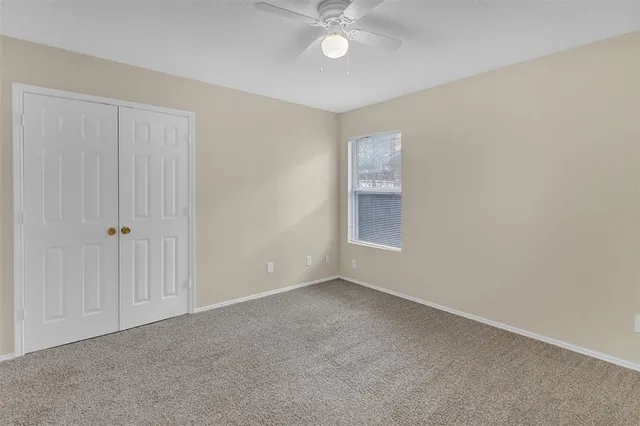 a view of an empty room with a fan