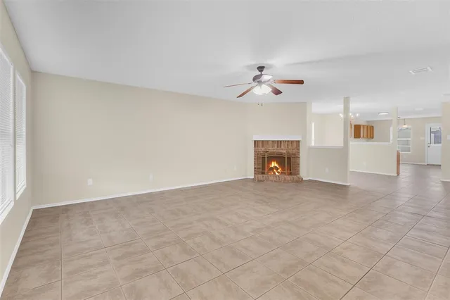 a view of a livingroom with a fireplace and a window