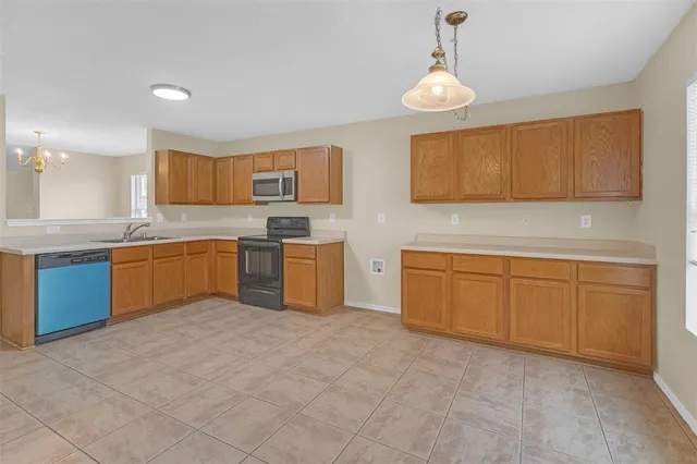 a kitchen with cabinets a sink and appliances