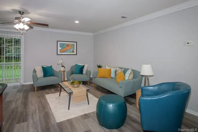 a living room with furniture and a potted plant