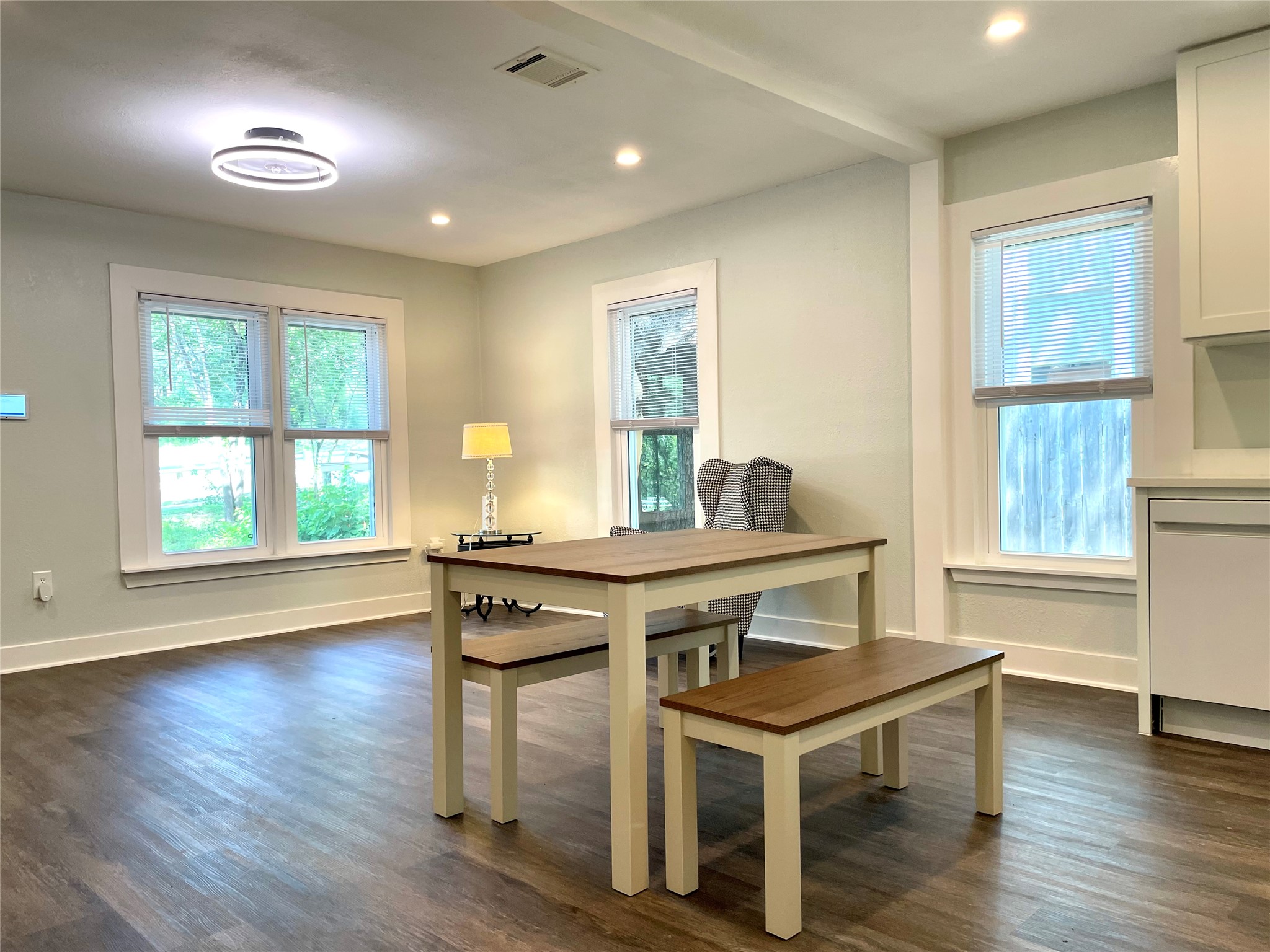 807 East Riverside Drive, Unit B Austin, TX 78704 - Photo 8 of 28 Bright windows and warm wood flooring create an inviting atmosphere for daily living and entertaining.
