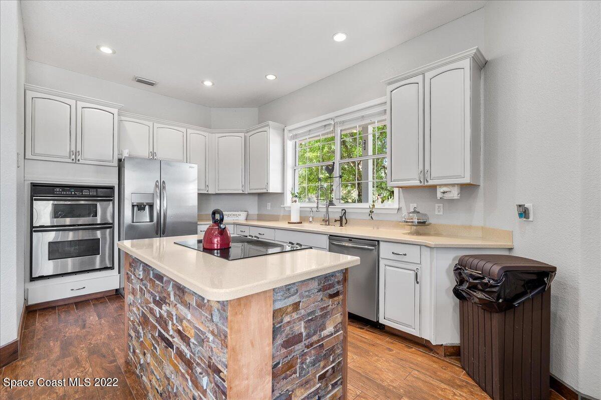 4450 Rayburn Road Cocoa, FL 32926 - Photo 11 of 45 a kitchen with a stove a sink and a refrigerator