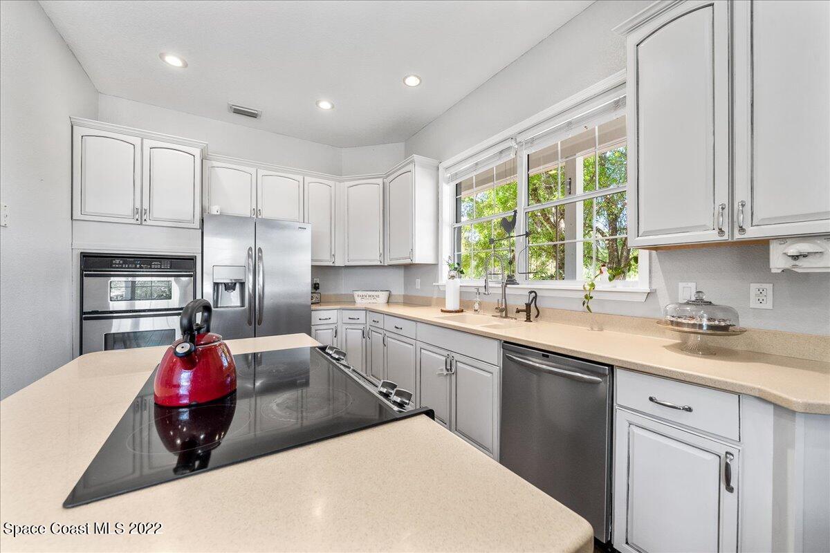 4450 Rayburn Road Cocoa, FL 32926 - Photo 13 of 45 a kitchen with a sink cabinets and window