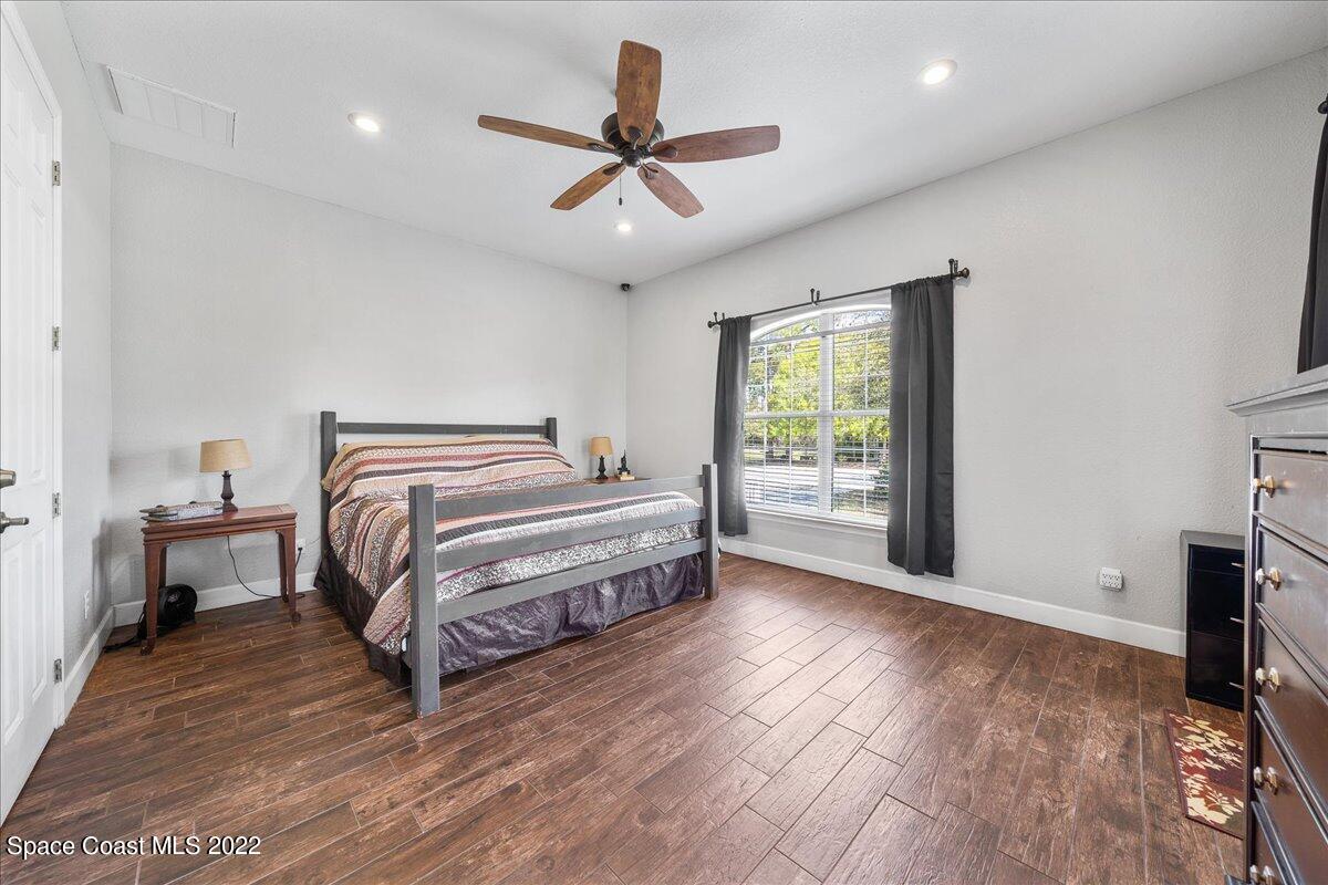 4450 Rayburn Road Cocoa, FL 32926 - Photo 15 of 45 a bedroom with a bed and a ceiling fan