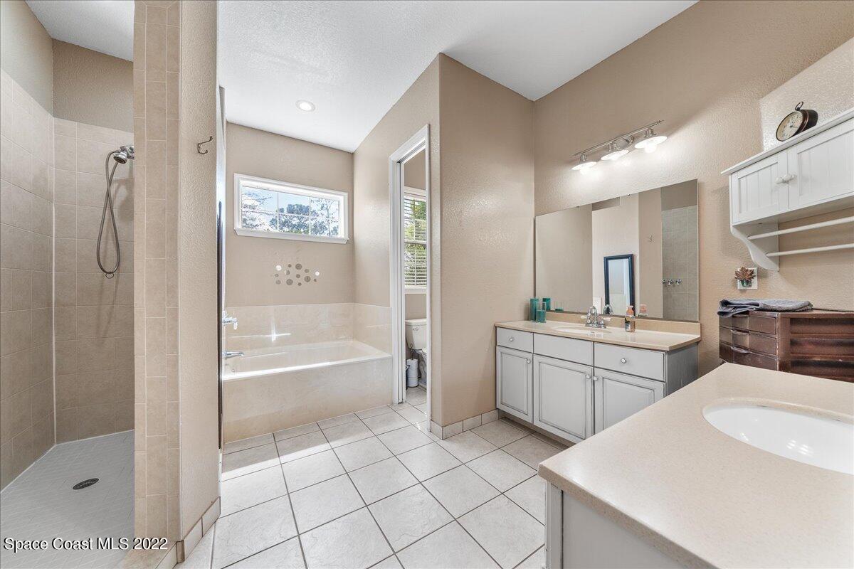 4450 Rayburn Road Cocoa, FL 32926 - Photo 17 of 45 a large bathroom with a tub sink shower and mirror