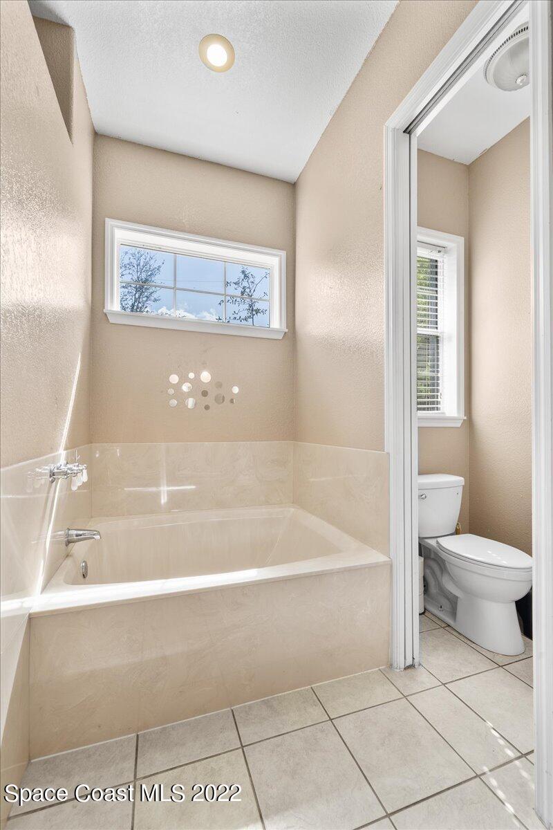 4450 Rayburn Road Cocoa, FL 32926 - Photo 18 of 45 a bath tub sitting next to a white toilet