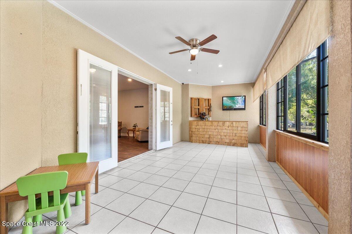 4450 Rayburn Road Cocoa, FL 32926 - Photo 27 of 45 a view of a hallway with wooden floor and windows