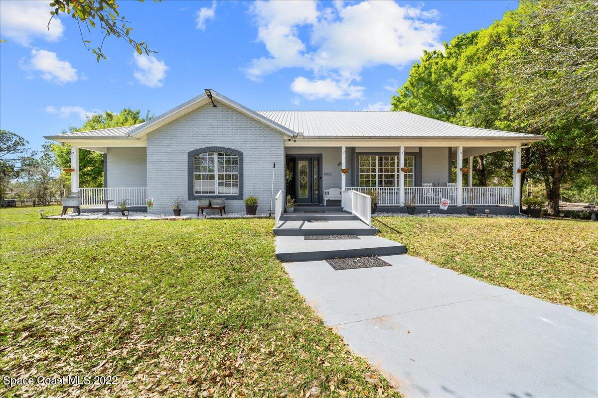 4450 Rayburn Road Cocoa, FL 32926 - Photo 4 of 45 a front view of a house with a yard