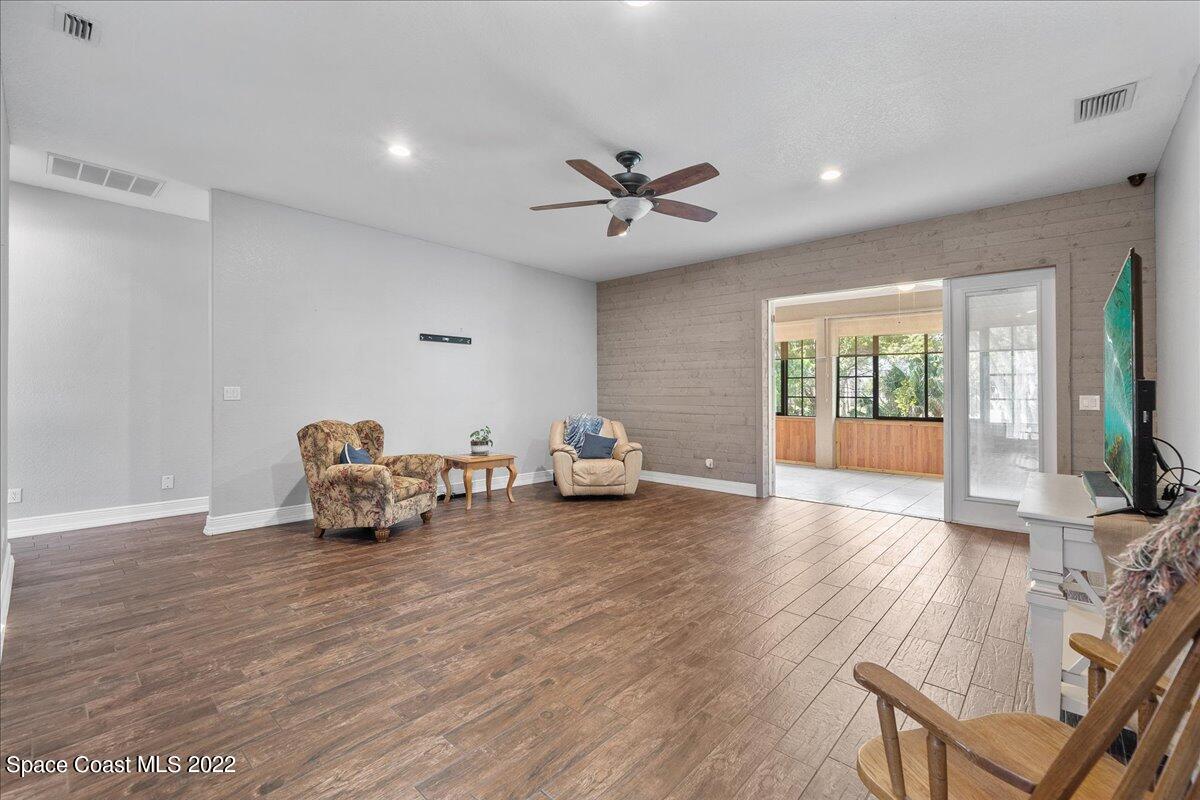 4450 Rayburn Road Cocoa, FL 32926 - Photo 6 of 45 a view of a livingroom with furniture wooden floor and a ceiling fan