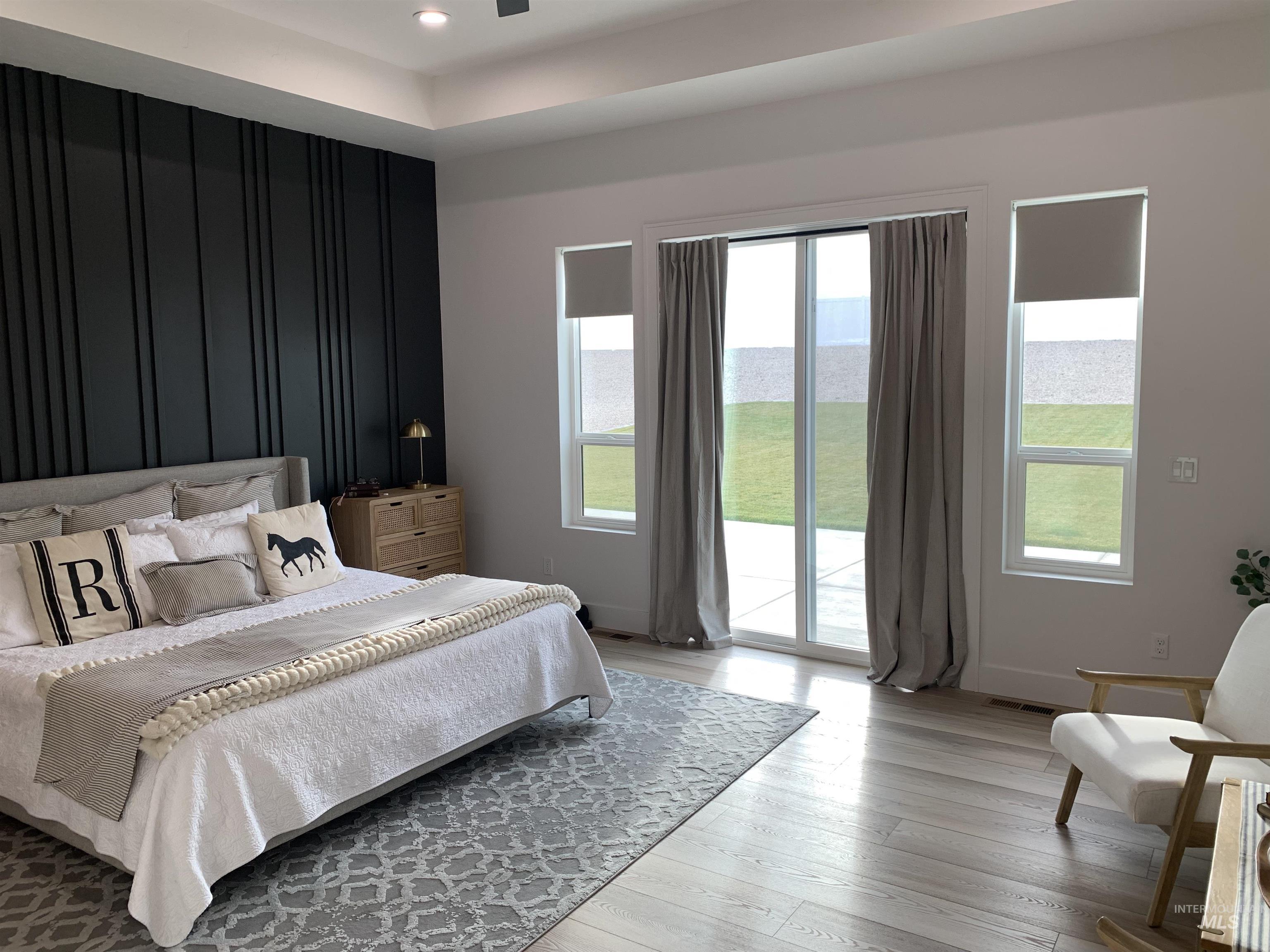 24501 Himark Way Caldwell, ID 83607 - Photo 11 of 27 Bedroom with access to exterior, light wood-style floors, ceiling fan, a water view, and recessed lighting