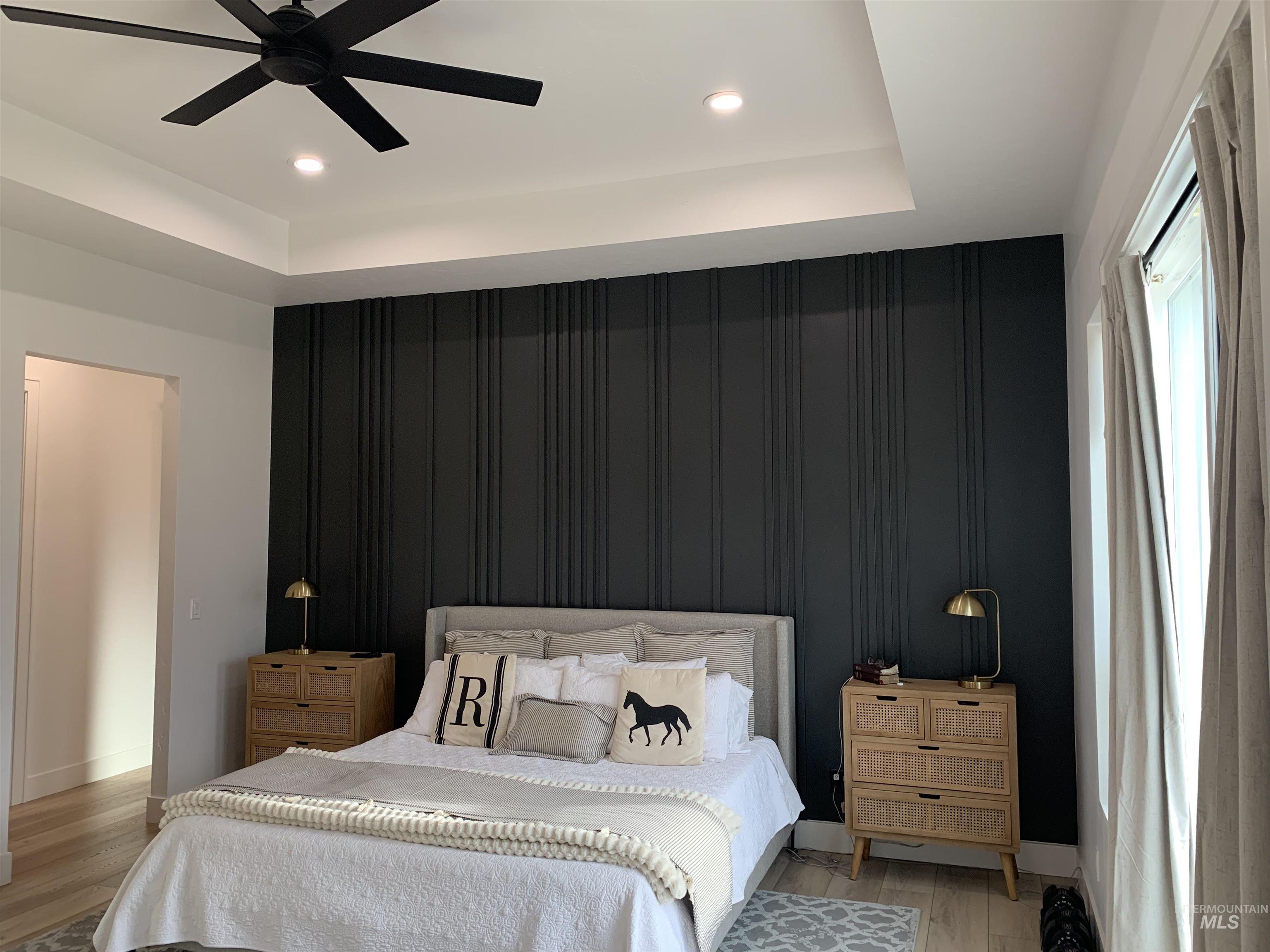 24501 Himark Way Caldwell, ID 83607 - Photo 12 of 27 Bedroom featuring a raised ceiling, ceiling fan, light wood-type flooring, recessed lighting, and an accent wall
