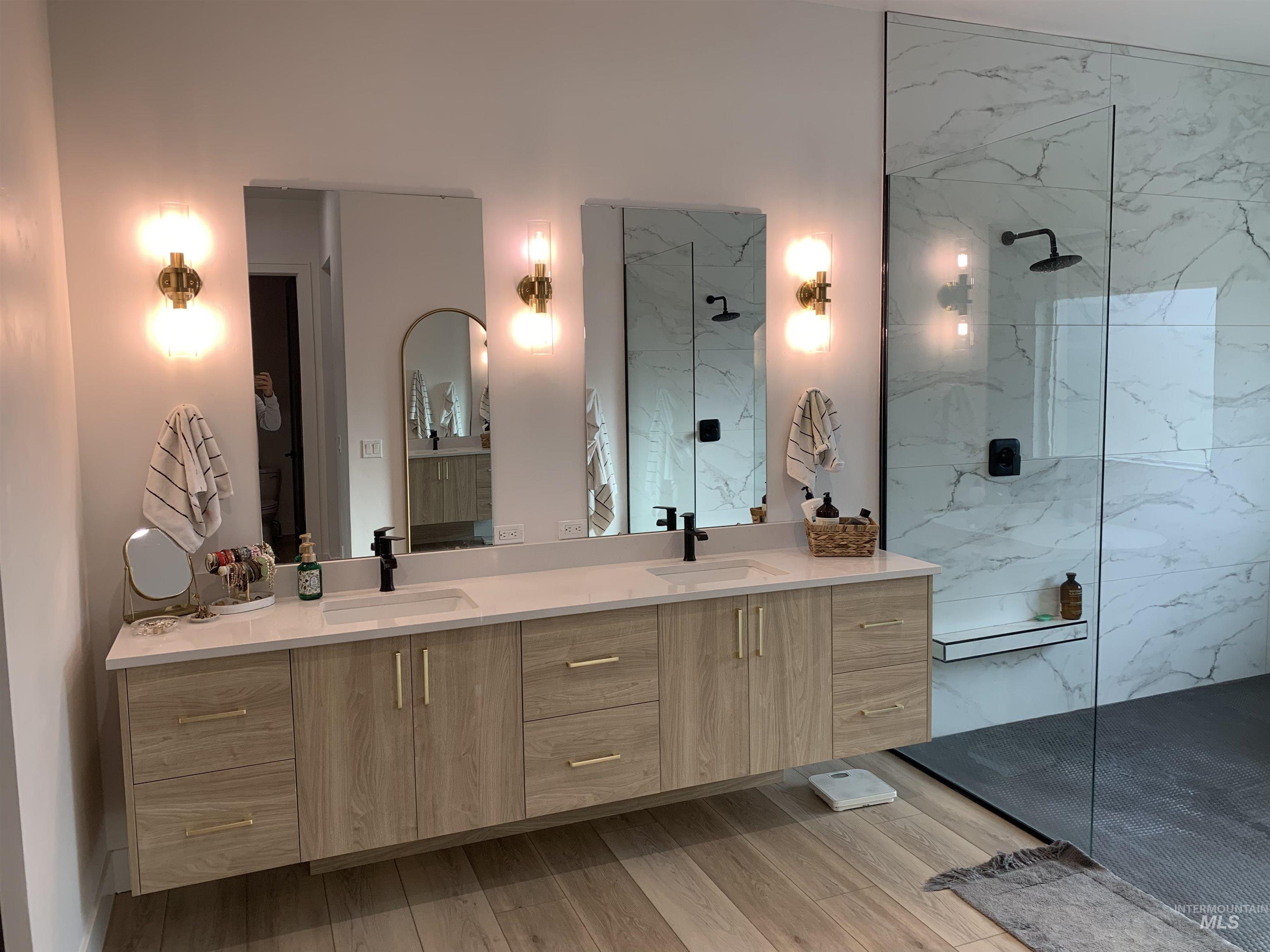 24501 Himark Way Caldwell, ID 83607 - Photo 14 of 27 Full bath featuring double vanity, a marble finish shower, and light wood-style flooring