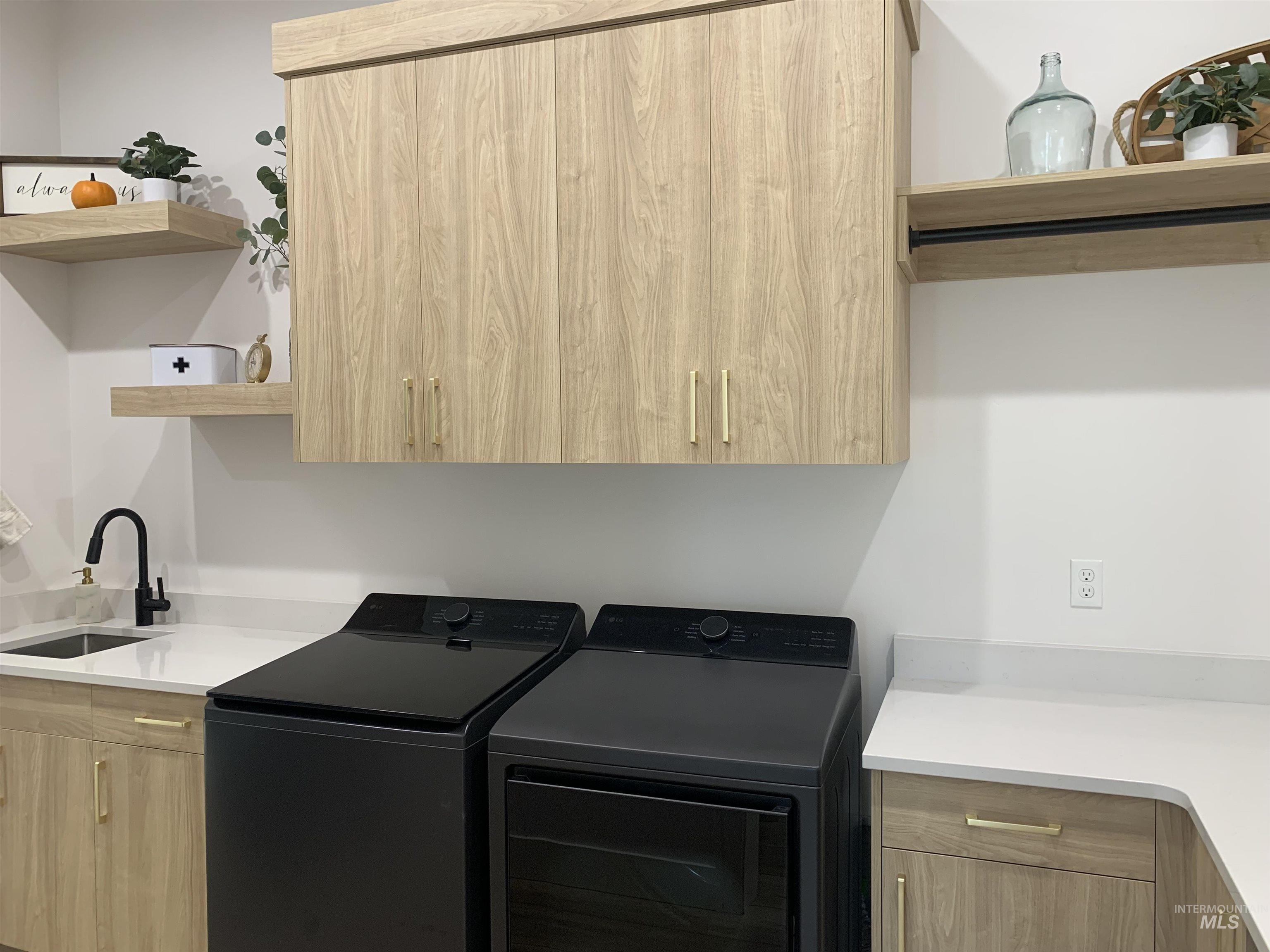 24501 Himark Way Caldwell, ID 83607 - Photo 16 of 27 Laundry room featuring cabinet space and washing machine and clothes dryer