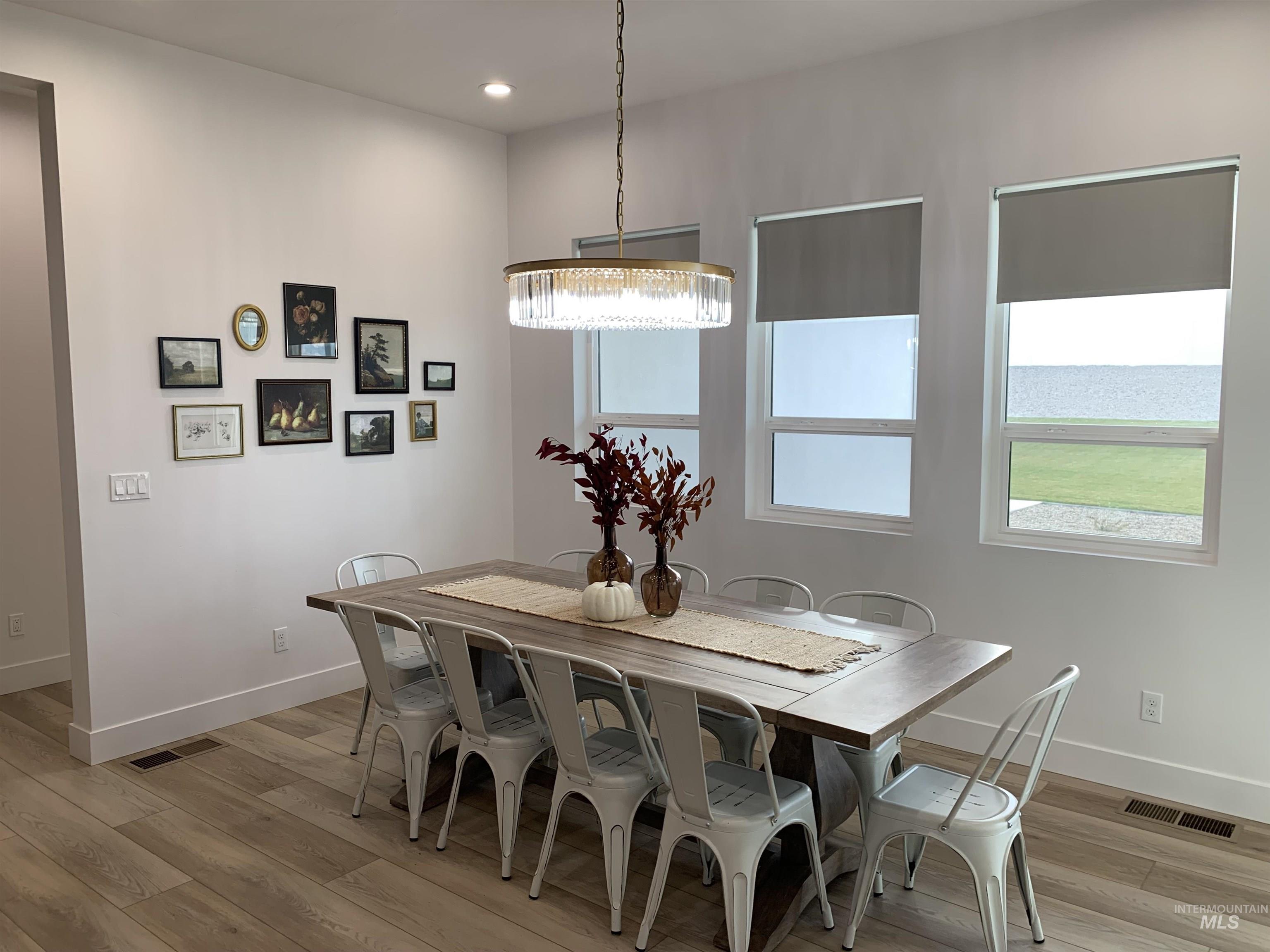 24501 Himark Way Caldwell, ID 83607 - Photo 19 of 27 Dining area with light wood-style flooring, recessed lighting, and a chandelier