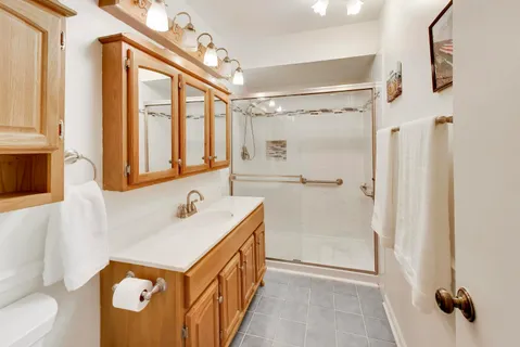 a bathroom with a sink a mirror and a shower