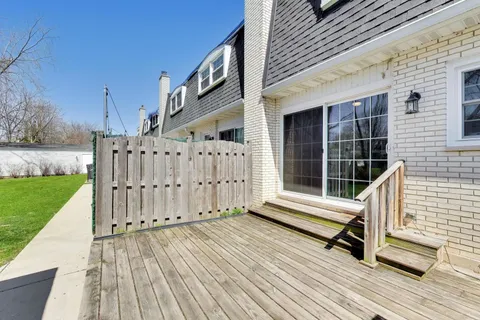 a view of a wooden deck with a yard