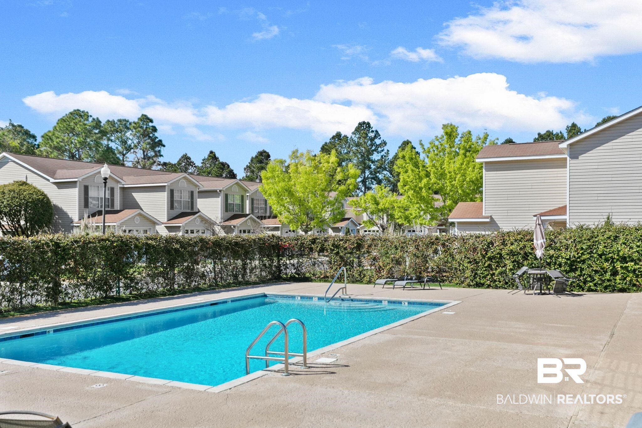 1517 Regency Road, Unit 83 Gulf Shores, AL 36542 - Photo 21 of 24 Community pool with a patio area
