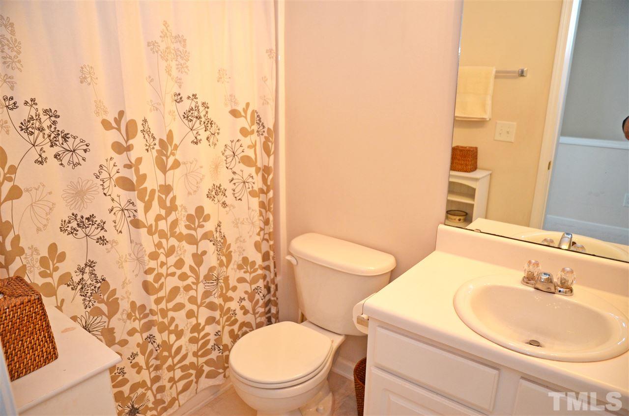 8520 Silhouette Place Raleigh, NC 27613 - Photo 17 of 17 a white toilet sitting next to a bathroom sink