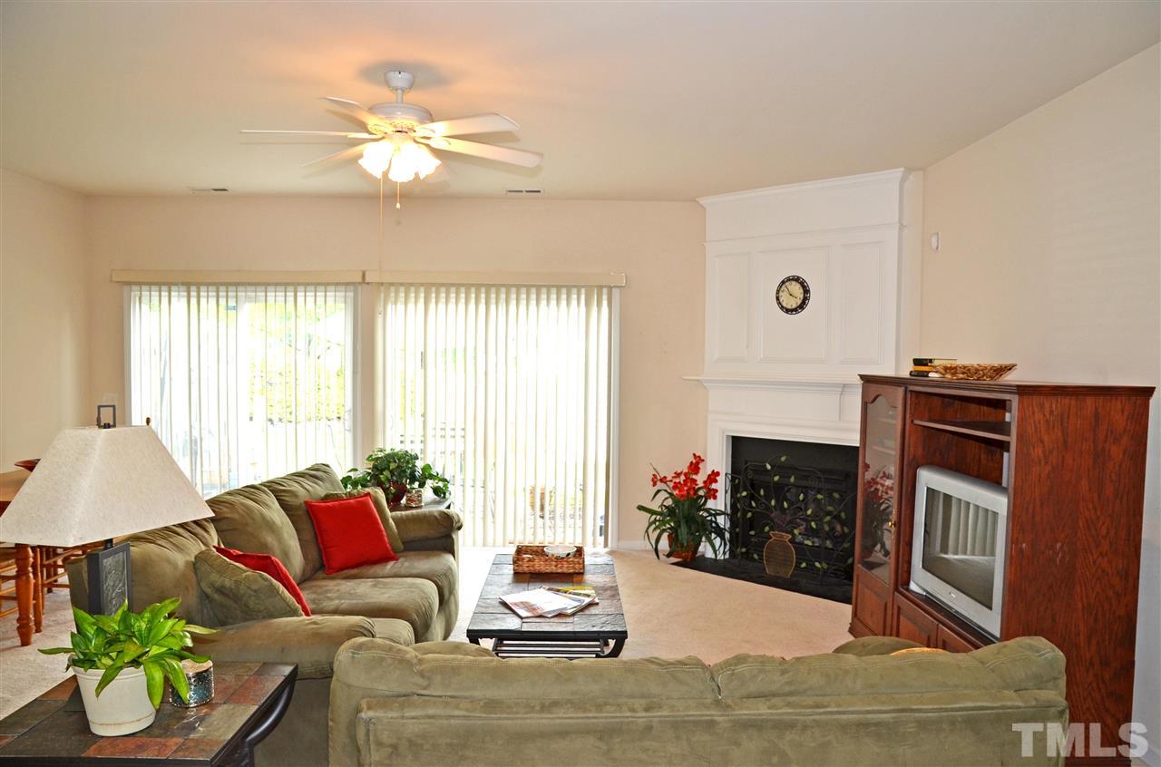 8520 Silhouette Place Raleigh, NC 27613 - Photo 3 of 17 a living room with furniture a fireplace and a flat screen tv