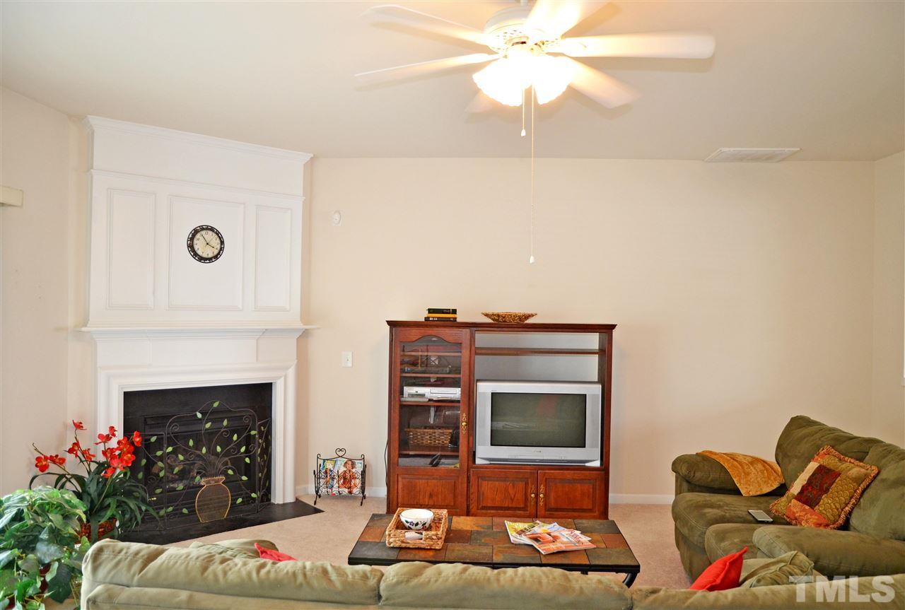 8520 Silhouette Place Raleigh, NC 27613 - Photo 4 of 17 a living room with furniture a fireplace and a potted plant