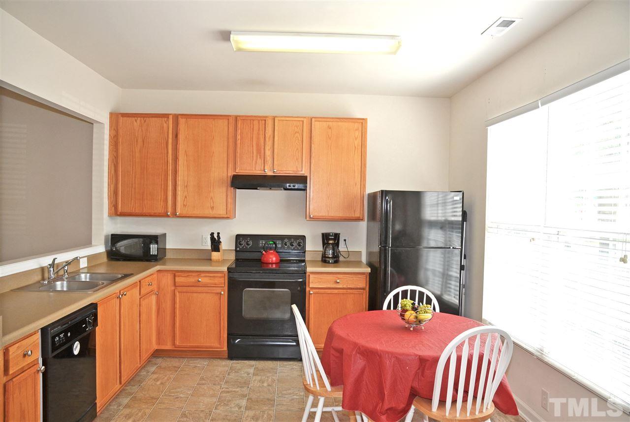 8520 Silhouette Place Raleigh, NC 27613 - Photo 6 of 17 a kitchen that has a sink and a stove in it