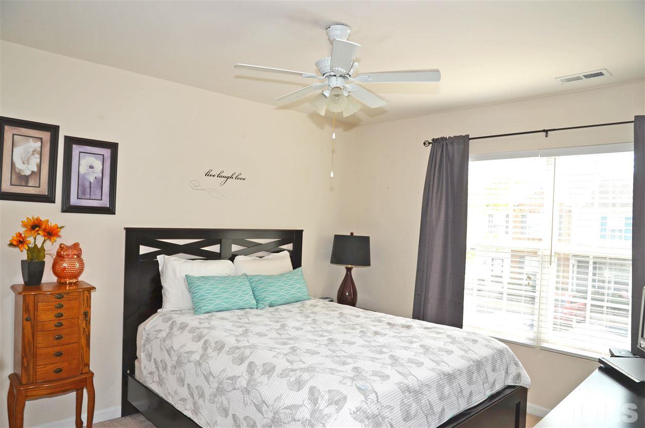 8520 Silhouette Place Raleigh, NC 27613 - Photo 10 of 17 a bedroom with a bed and a window