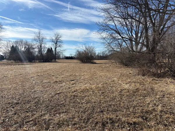 a view of a field with an trees