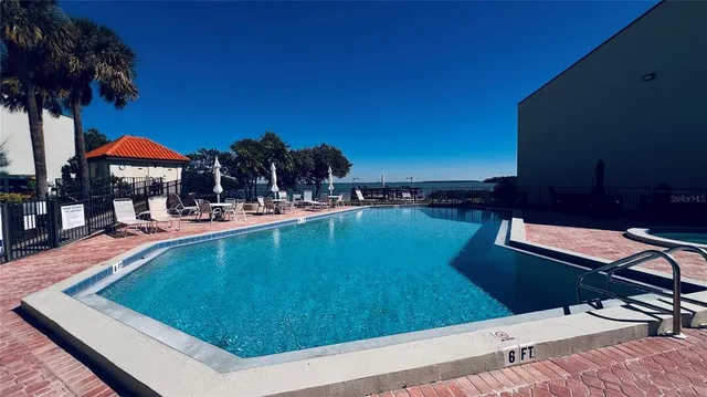 a swimming pool with outdoor seating and yard