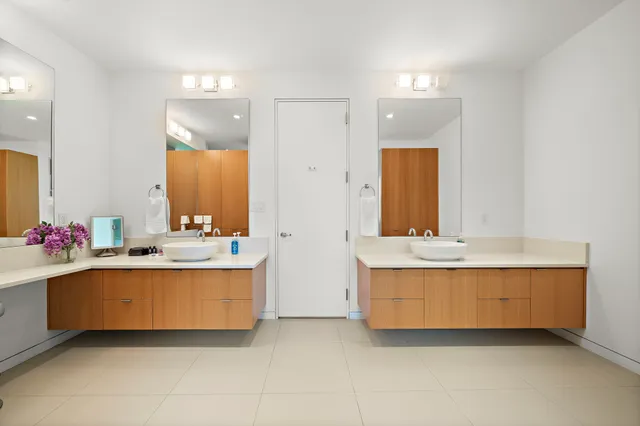 a bathroom with a tub sink and mirror