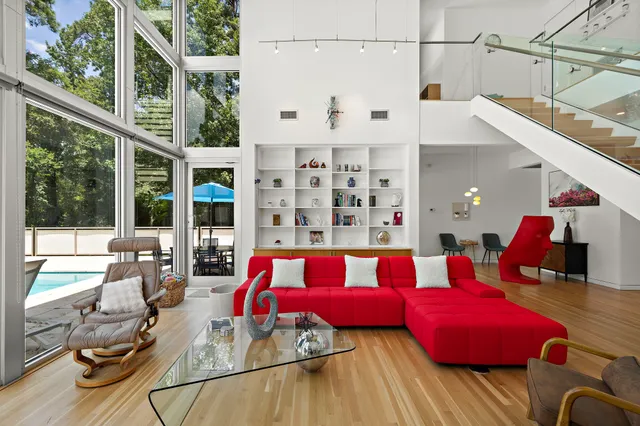 a living room with furniture and a floor to ceiling window