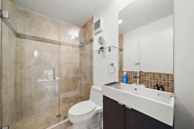 a bathroom with a sink toilet and shower