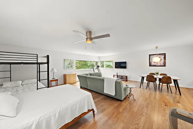 a bedroom with furniture and a wooden floor