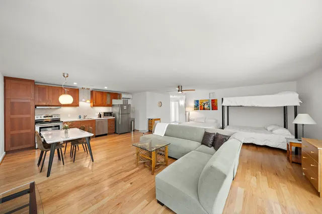 a living room with furniture and a wooden floor