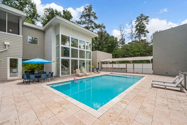 a view of a house with swimming pool and sitting area