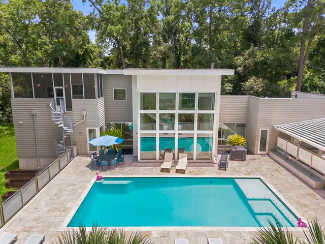 a house view with a seating space and a garden
