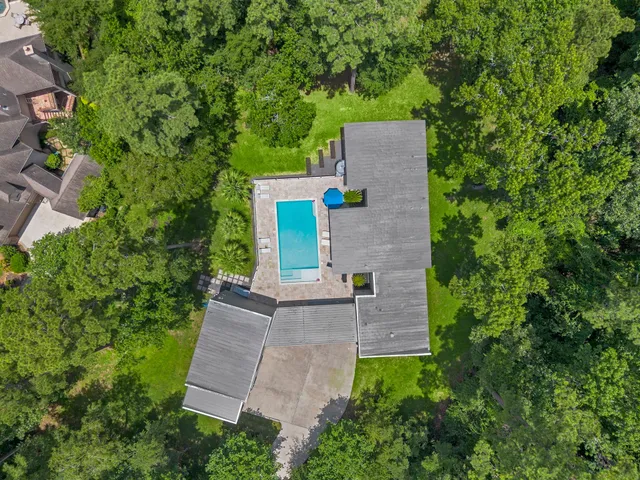 an aerial view of a house with a yard and garden
