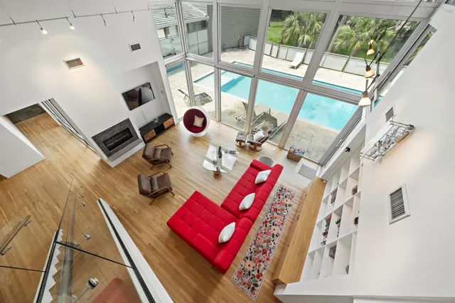 a view of living room with furniture and a floor to ceiling window
