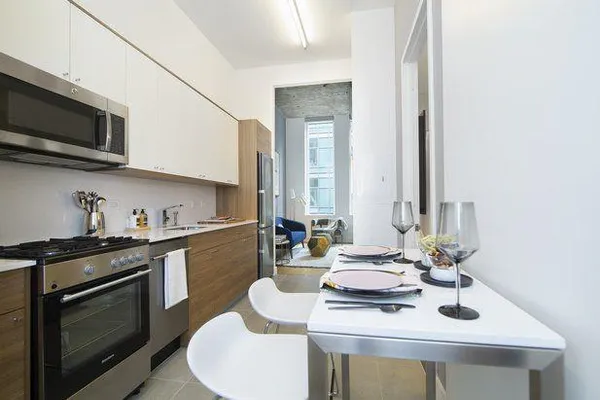 a kitchen with stainless steel appliances a sink a stove and microwave