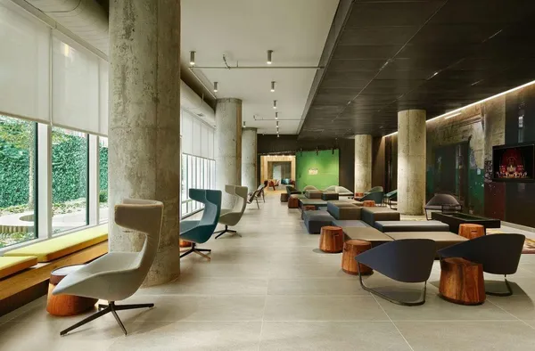 a living room with furniture gym equipment and a large window