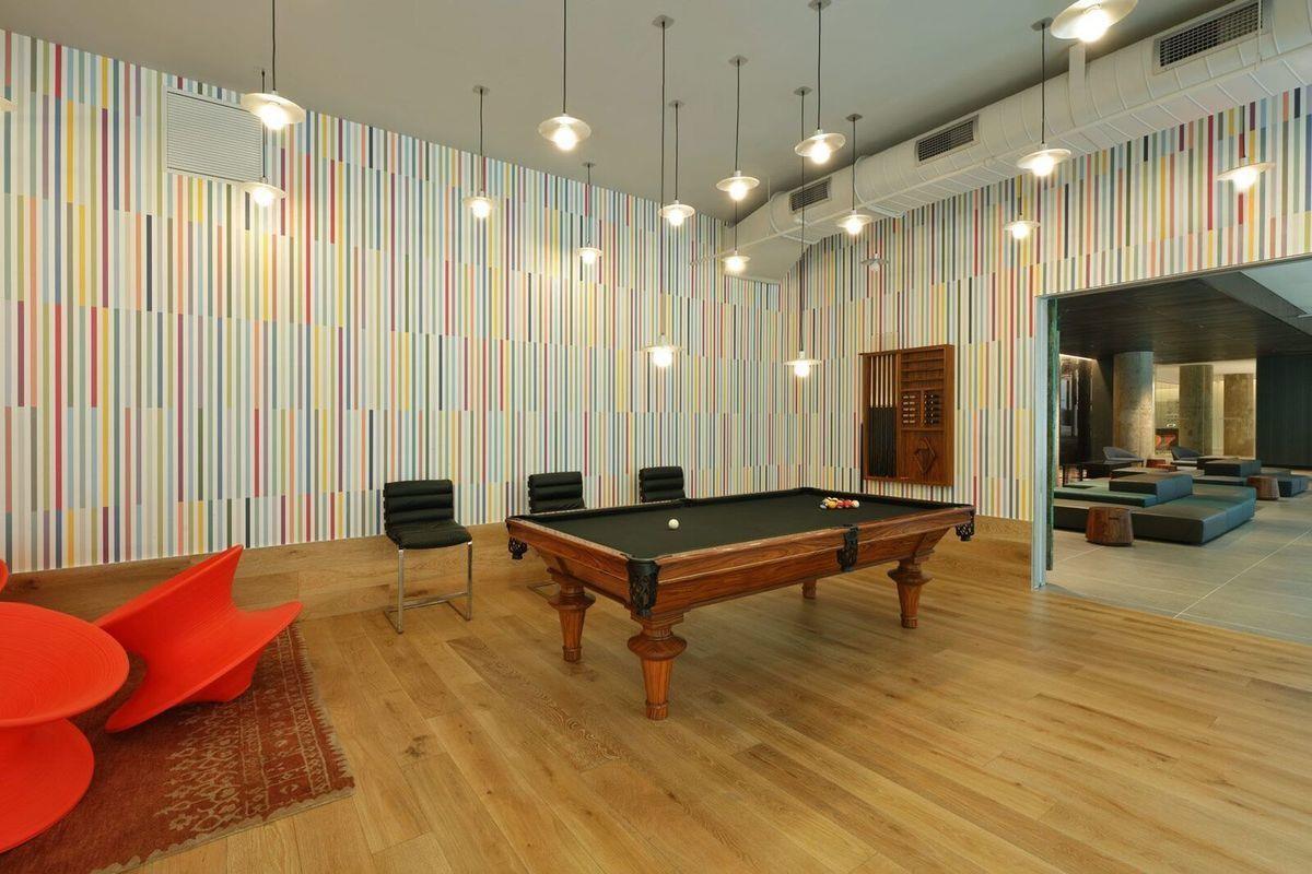 43-22 Queens Street, Unit 237 Queens, NY 11101 - Photo 14 of 14 a room with pool table and windows