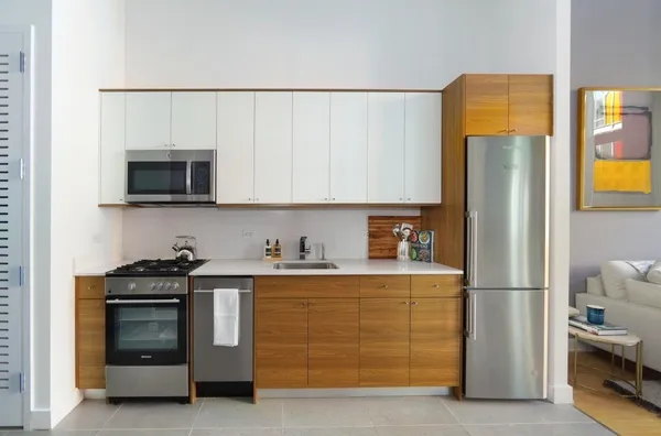 a kitchen with stainless steel appliances a stove a refrigerator and a sink