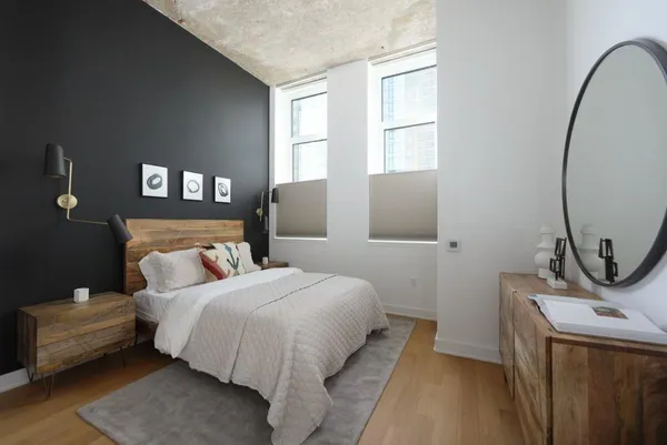 a bedroom with a bed and a mirror