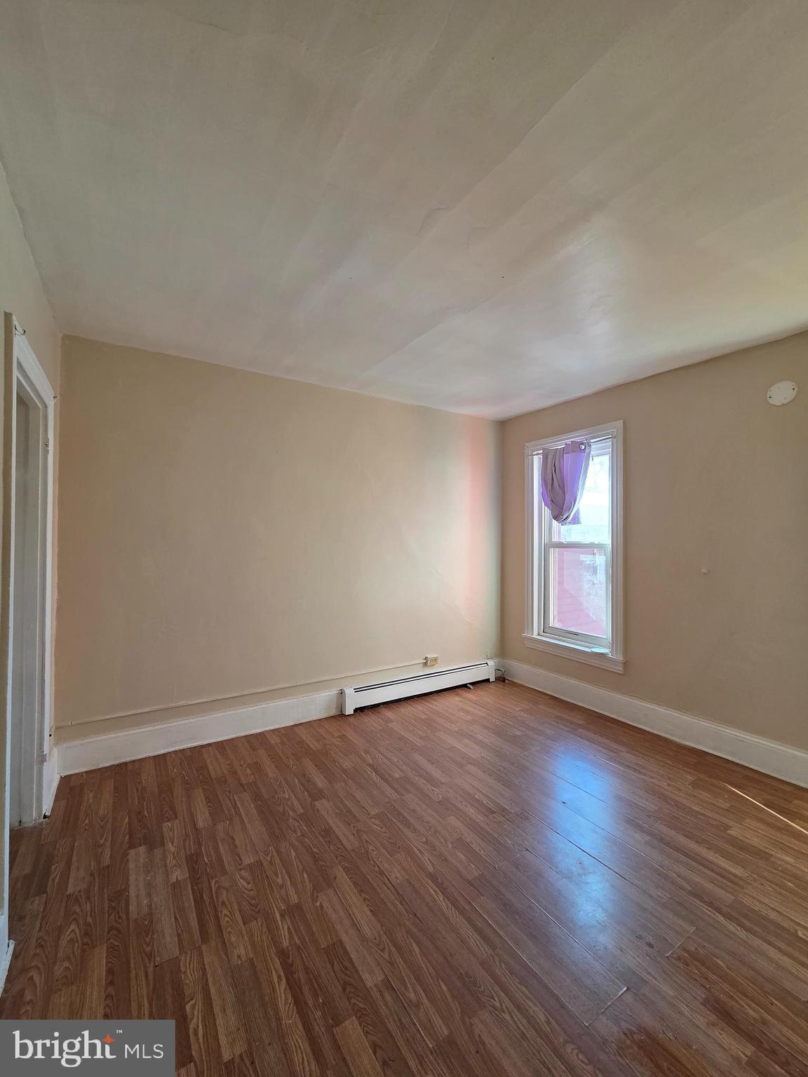 42 Maple Street Reading, PA 19602 - Photo 13 of 18 an empty room with wooden floor and windows