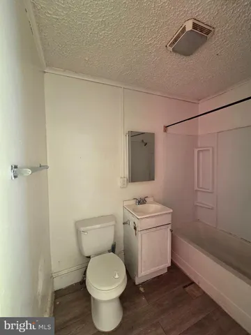 a bathroom with a toilet a sink and a shower