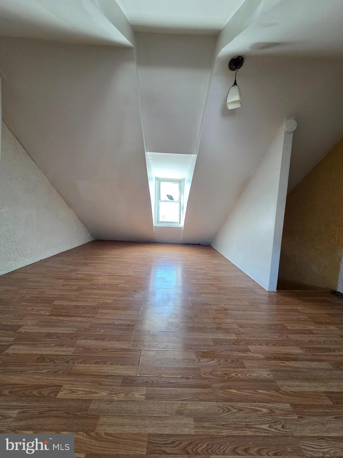 42 Maple Street Reading, PA 19602 - Photo 14 of 18 an empty room with wooden floor and windows