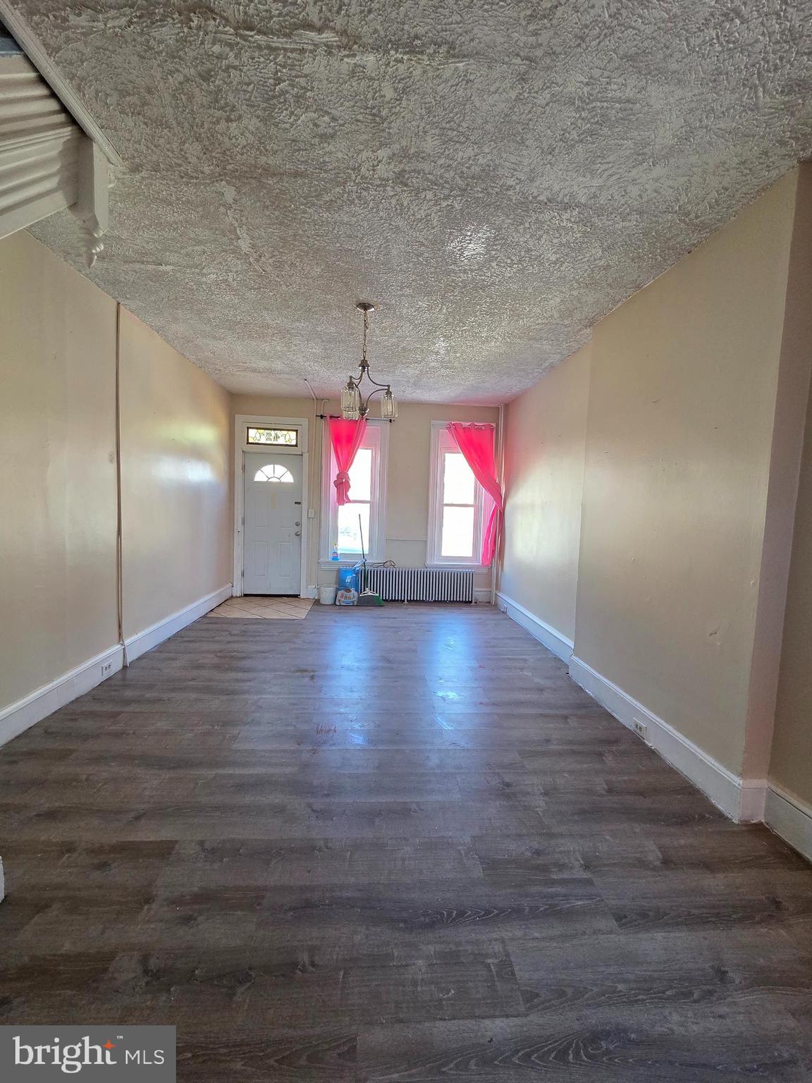 42 Maple Street Reading, PA 19602 - Photo 6 of 18 an empty room with wooden floor and windows