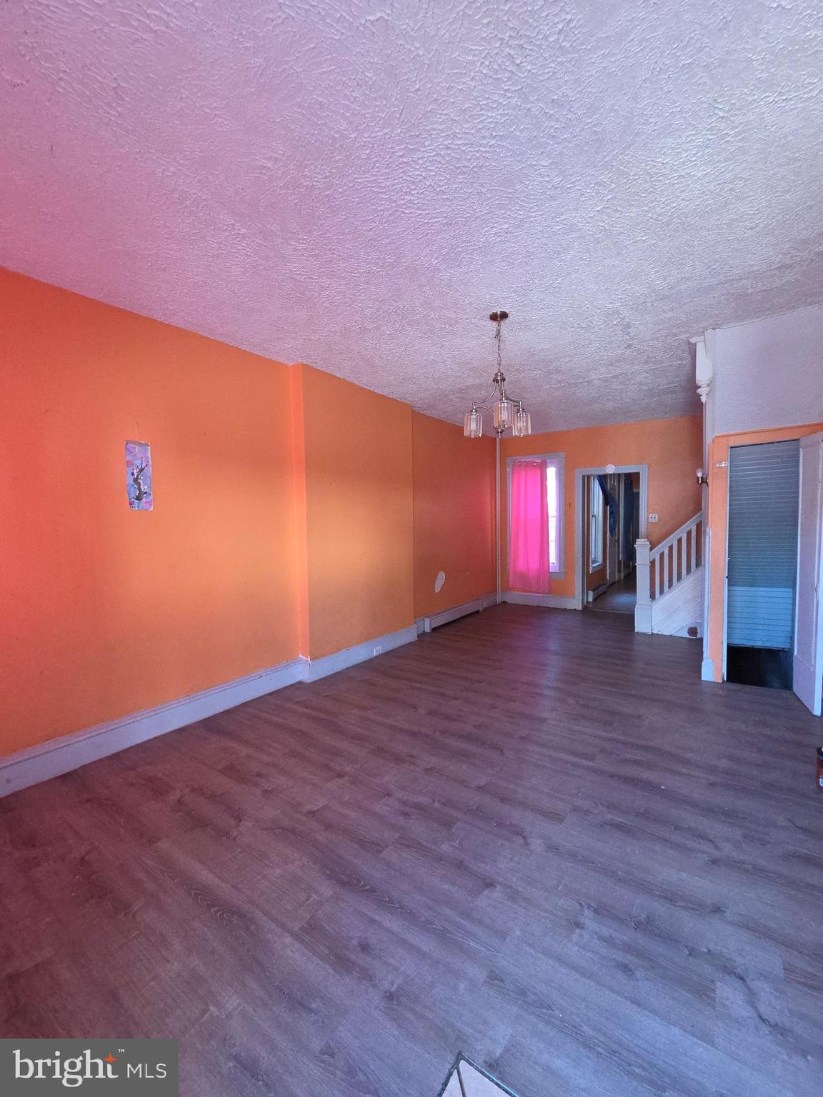 42 Maple Street Reading, PA 19602 - Photo 6 of 21 a view of an empty room with wooden floor and a window