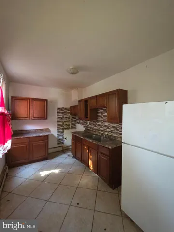 a kitchen with granite countertop a refrigerator and a stove